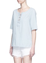 Front View -Click To Enlarge Washed denim lace-up top