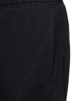Detail View -Click To Enlarge Perforated leather patch jogging pants