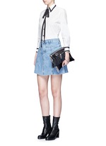 Figure View -Click To Enlarge Pear star chain embellished leather fringe clutch