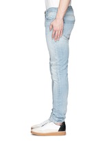 Detail View -Click To Enlarge Repaired knee patch distressed skinny jeans
