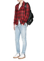 Figure View -Click To Enlarge Repaired knee patch distressed skinny jeans