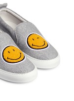 Detail View -Click To Enlarge 'Smile' fleece patch jersey skate slip-ons