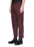 Front View - Click To Enlarge - SIKI IM / DEN IM - 'Ponyboy' face embroidered frayed cuff chinos