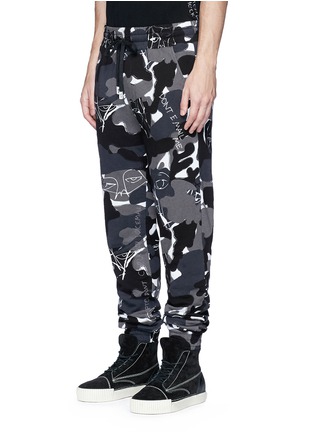 Front View - Click To Enlarge - HACULLA - Camouflage print scribble embroidered sweatpants