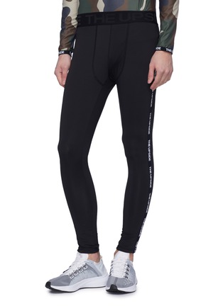 Front View - Click To Enlarge - THE UPSIDE - Logo stripe outseam performance leggings