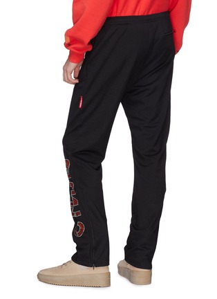 Back View - Click To Enlarge - HERON PRESTON - Cyrillic embellished outseam track pants