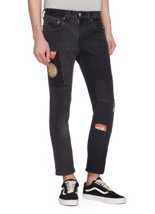 Front View - Click To Enlarge - 10720 - Mix badge appliqué patchwork jeans