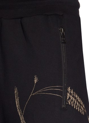DRIES VAN NOTEN Hero graphic embroidered jogging pants Women