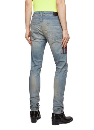 Back View - Click To Enlarge - AMIRI - LIGHT WASH DISTRESSED FLANNEL CORE SIDE LOGO KNEE SLITS SKINNY JEANS