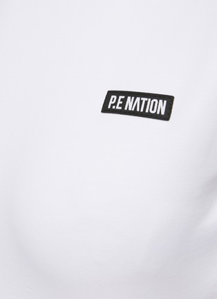  - P.E NATION - ‘Volley’ Back Cut Out Logo Elastic Hem Cropped T-Shirt