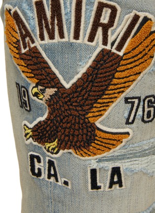  - AMIRI - Varsity Eagle Logo Distressed Skinny Jeans