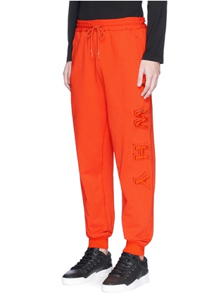 Front View - Click To Enlarge - FENG CHEN WANG - 'WHY' padded appliqué drawstring pocket sweatpants
